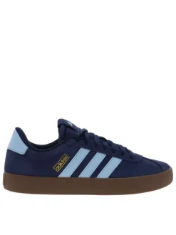 Baskets tennis bleues à talon plat avec un patch de la marque à la languette