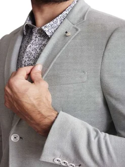 Blazer en maille piquée vert sauge uni à coupe ajustée fermé par deux boutons