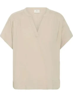 Blouse beige unie pourvue d'un col tunisien et de manches courtes