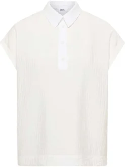 Blouse blanche unie pourvue d'un col boutonnée et de manches courtes