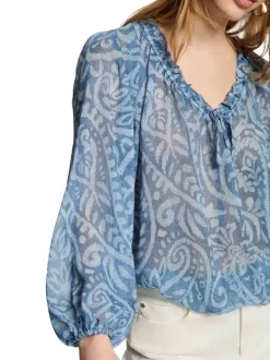 Blouse bleue à coupe ample pourvu d'un col v et de manches longues