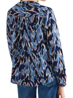 Blouse bleue à motifs pourvue d'une coupe droite et d'un col zippé