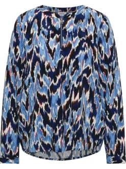Blouse bleue à motifs pourvue d'une coupe droite et d'un col zippé