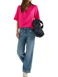 Blouse fuchsia unie pourvue de manches courtes et d'un col tunisien