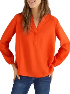 Blouse orange unie pourvue d'une coupe droite et d'un col tunisien
