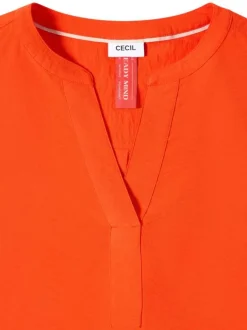 Blouse orange unie pourvue d'une coupe droite et d'un col tunisien