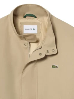 Blouson beige à coupe ajustée pourvu d'un col à boutons pression