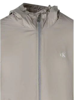 Blouson beige à coupe ajustée pourvu d'un col à capuche avec cordon de serrage