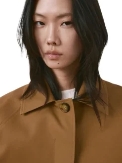 Blouson brun uni pourvu d'une coupe oversize et d'un col chemise