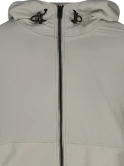 Blouson en coton beige uni avec une coupe droite et une fermeture zippée