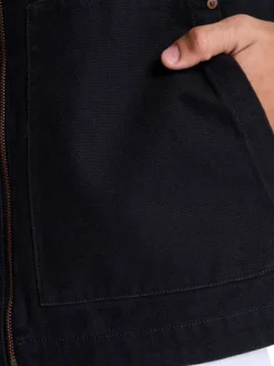 Blouson en coton noir uni sans manche avec une coupe droite