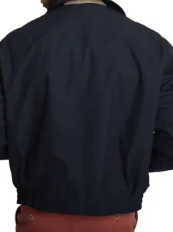 Blouson marine uni avec une coupe ajustée, un zip et des boutons-pressions