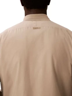 Bomber beige à coupe ajustée pourvu d'une fermeture zippée argentée