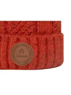 Bonnet orange uni avec trois pompons interchangeables et mailles tressées