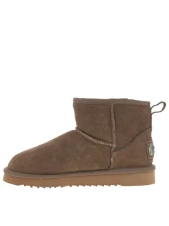 Boots en cuir de vachette beige, fourrées en laine, à semelle plate adhérente