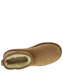Boots en cuir naturel à talon plat avec intérieur fourré et patch de la marque