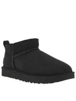 Boots en cuir noires à semelle à talon plat et fourrure à l'intérieur
