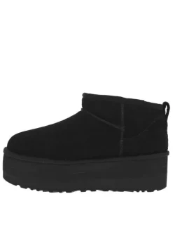 Boots en cuir noires à semelle à talon semi-compensée et fourrure