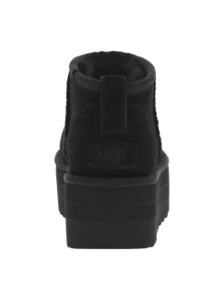 Boots en cuir noires à semelle à talon semi-compensée et fourrure