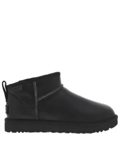 Boots en cuir noir mat à talon plat avec une semelle cranté et à slip-on