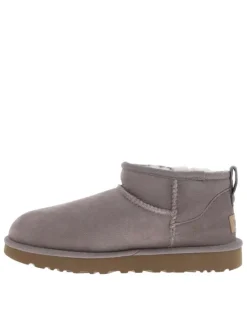 Boots rose à talon plat, fourrées avec tirette arrière et étiquette de la marque