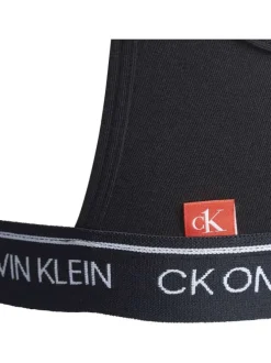 Brassière noire unie avec petite étiquette d'authentification rouge à l'arrière
