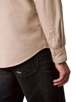 Chemise en coton beige unie avec une coupe droite et un col à revers