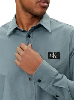 Chemise en coton bleue unie à coupe slim fit et à manches longues boutonnées