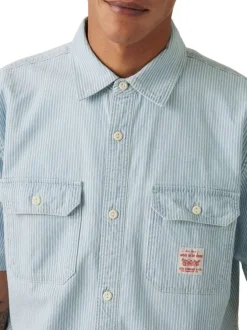 Chemise en coton bleu rayée avec une coupe droite et un col à revers