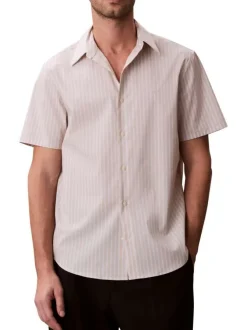 Chemise à rayures verticales en coton beige pourvue d'un col à revers