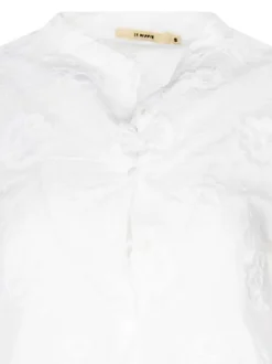 Chemisier en coton blanc brodé avec un col rond et une coupe ajustée