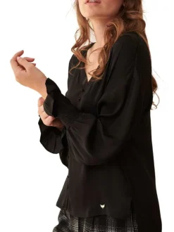 Chemisier noir uni avec une coupe fluide et des manches longues