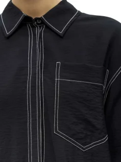 Chemisier noir uni pourvu d'une coupe droite et de manches longues