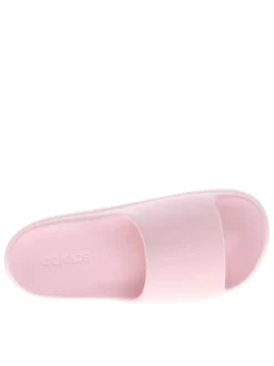 Claquettes roses à talon plat avec le logo de la marque embossé dans la semelle