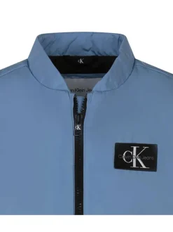 Doudoune sans manches bleue unie à col montant et avec le logo de la marque
