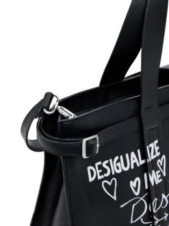 Grand sac cabas noir fermé par un zip avec des écritures imprimées