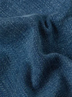 Jean en coton bleu avec une coupe slim et des passants pour ceinture