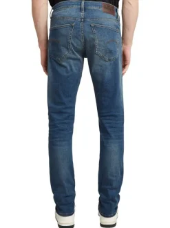 Jean en coton bleu avec une coupe slim et des passants pour ceinture