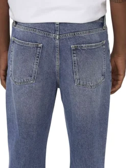 Jean en coton bleu délavé avec une coupe baggy et des passants à la taille