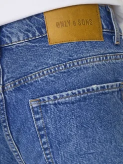 Jean en coton bleu délavé avec une coupe regular fit et une braguette à boutons