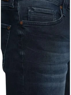 Jean en coton bleu indigo délavé avec une taille mi-haute et une coupe slim