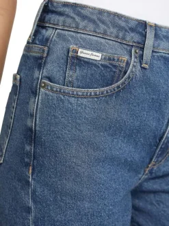 Jean en coton mélangé bleu délavé avec une coupe mom et une taille haute