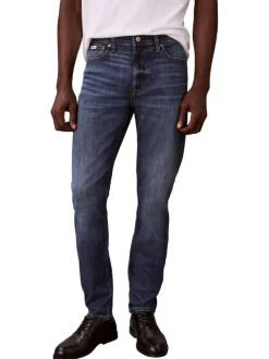 Jean en coton mélangé indigo uni avec une coupe slim à zip et bouton