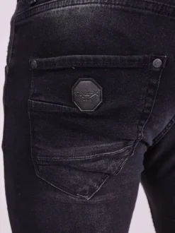 Jean en coton noir uni avec une coupe skinny et un effet troué