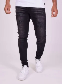 Jean en coton noir uni avec une coupe skinny et un effet troué