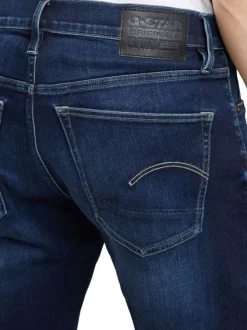 Jean en coton nuit avec une coupe slim et des passants pour ceinture