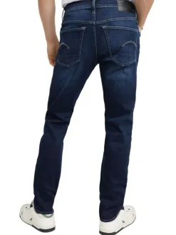 Jean en coton nuit avec une coupe slim et des passants pour ceinture