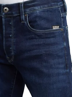 Jean en coton nuit avec une coupe slim et des passants pour ceinture