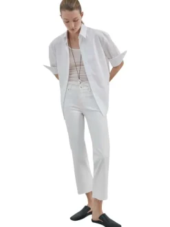 Jean en lin blanc uni avec une coupe bootcut et des poches raglan à l'avant