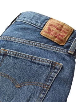 Jean 5 poches en coton bleu délavé avec une coupe large et jacron beige